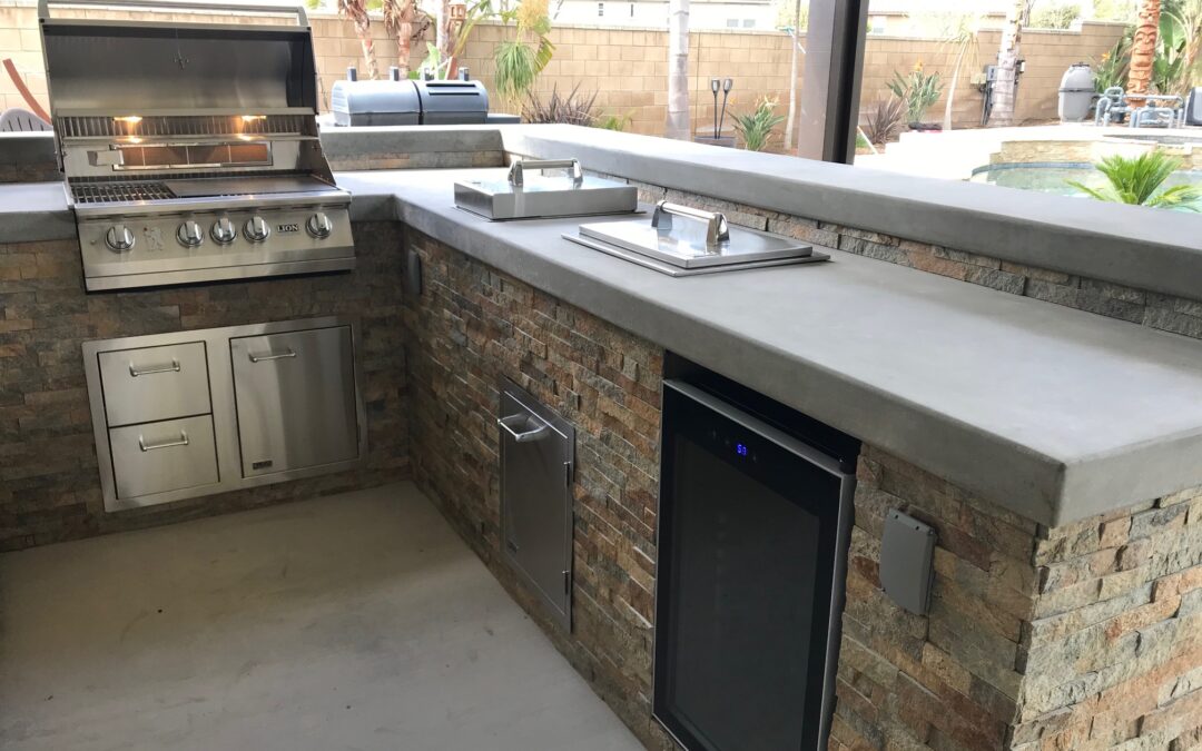 Custom L-shaped BBQ island in Eastvale, California, featuring a built-in grill, countertop space, and storage cabinets, designed for outdoor cooking and entertaining